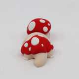 3D printed red and white polka dot mushroom toy with sensory texture on a white background
