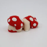 3D printed red and white polka dot mushroom sensory toy on white background