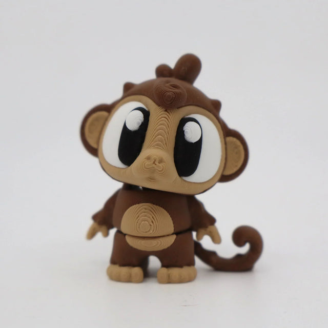3D printed sensory monkey toy with large eyes and brown textured body on white background