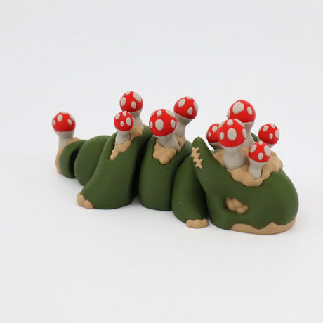 Green sensory toy caterpillar with red and white mushrooms, 3D printed for tactile play