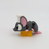 Cute 3D printed mouse toy with chef hat lying on yellow cheese, sensory toy for kids