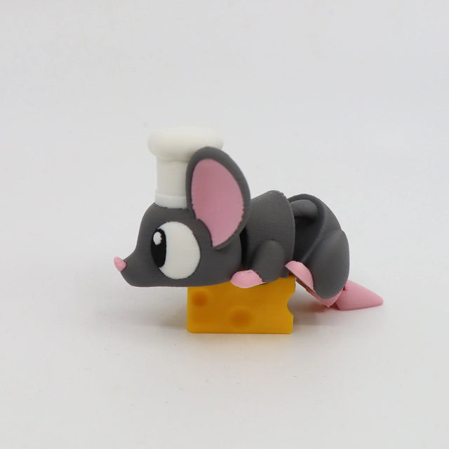 Cute 3D printed mouse toy with chef hat lying on yellow cheese, sensory toy for kids