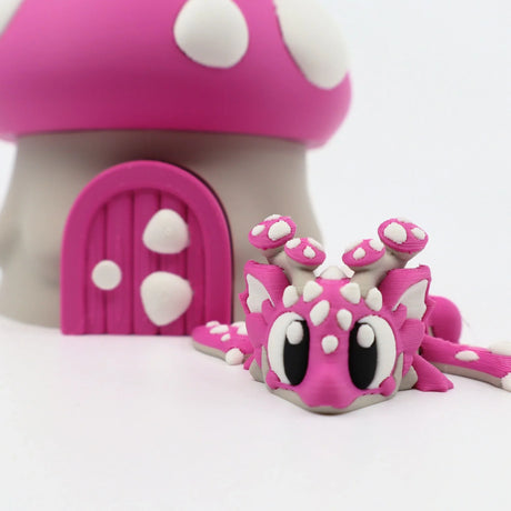 Pink 3D printed flexi dragon toy with mushroom house, sensory fidget for kids