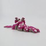 Pink 3D printed flexi dinosaur toy with white spikes, sensory fidget for kids