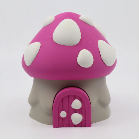 Pink mushroom house fidget toy with white spots and door, 3D printed sensory tool for kids