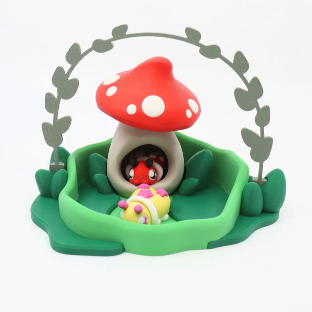 3D printed sensory toy featuring a red mushroom house with cute animal figures, green base