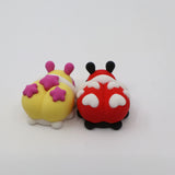 Two colorful 3D printed sensory bug toys with heart and star shapes on a white background