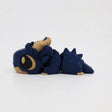 Blue and beige 3D printed sensory dragon toy with large eyes, lying on white background