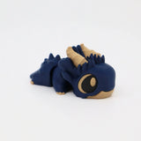 Blue and beige 3D printed sensory dragon toy with large eyes on white background