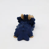 Blue 3D printed sensory dinosaur toy with beige horns on a white background