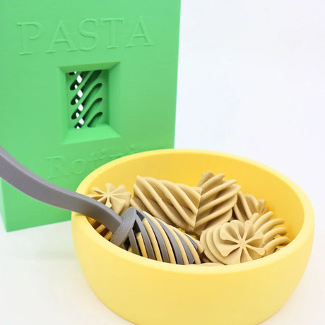 3D printed sensory pasta toys in yellow bowl with green pasta-themed background