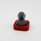 3D printed gray penguin fidget toy in red base, sensory-friendly design for kids
