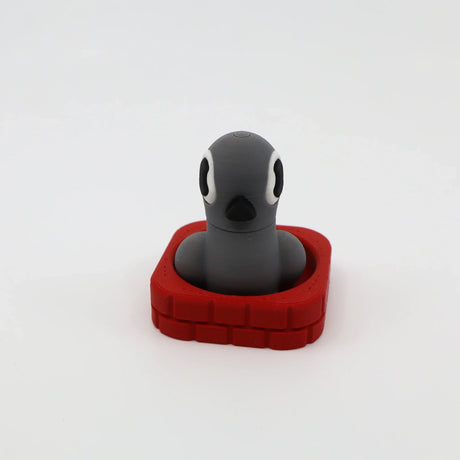 3D printed gray penguin fidget toy in red base, sensory-friendly design for kids