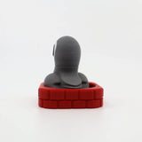 3D printed sensory toy with gray figure in red brick base, ideal for fidgeting and tactile play