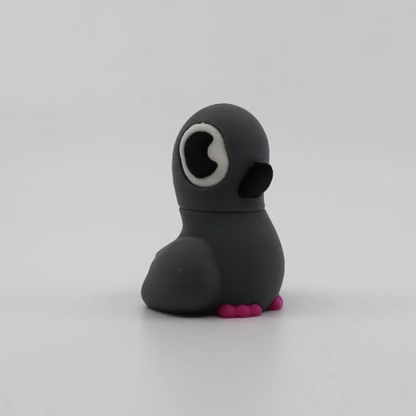 Gray 3D printed penguin fidget toy with pink feet, sensory-friendly design for kids