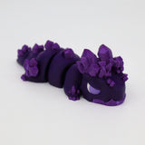 Purple 3D printed sensory toy caterpillar with crystal-like ridges on white background