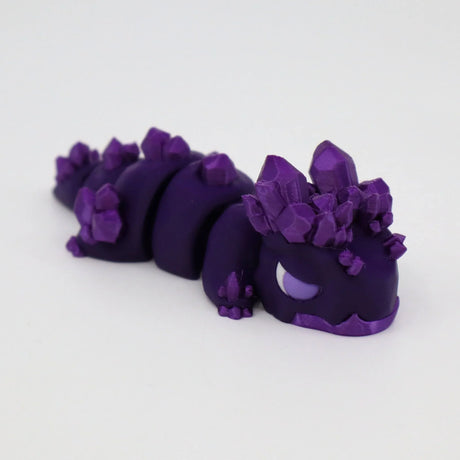 Purple 3D printed sensory toy caterpillar with crystal-like ridges on white background
