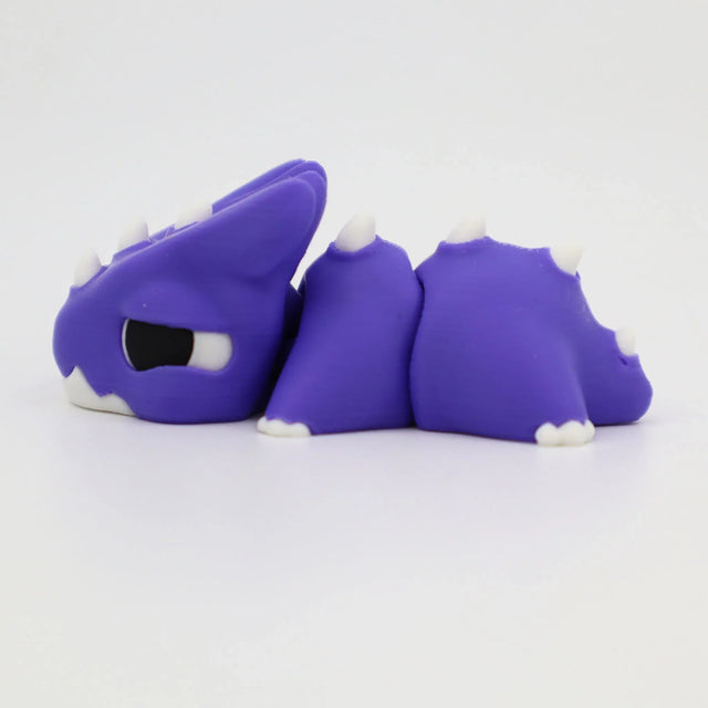 Purple 3D printed sensory toy dragon with white spikes on a white background