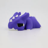 Purple 3D printed sensory dragon toy with white horns and black eyes on white background.