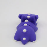 Purple 3D printed dinosaur sensory toy with white spikes on a white background