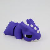 Purple 3D printed dragon sensory toy with white spikes, designed for sensory play
