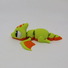 Green and orange 3D printed pterodactyl sensory toy with flexible joints on white background