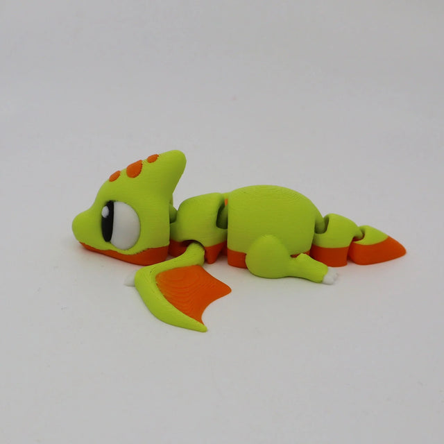 Green and orange 3D printed pterodactyl sensory toy with flexible joints on white background