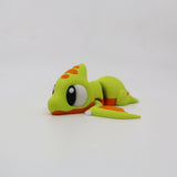 Cute green and orange 3D printed pterodactyl sensory toy with big eyes on white background
