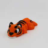 Orange 3D printed tiger sensory toy with black stripes on a white background