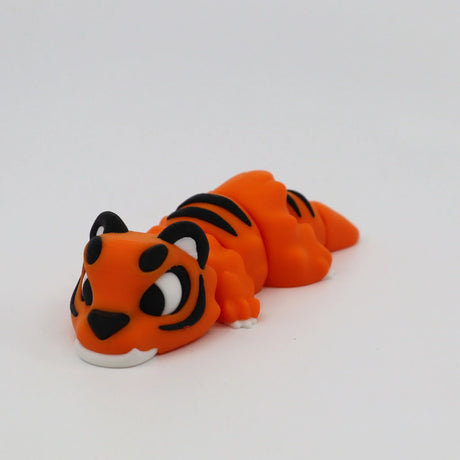 Orange 3D printed tiger sensory toy with black stripes on a white background