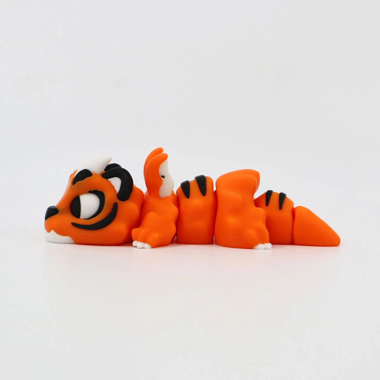 Orange 3D printed tiger sensory toy with black stripes, poseable and flexible design