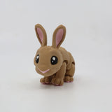 Cute 3D printed brown rabbit sensory toy with jointed limbs and big eyes on a white background