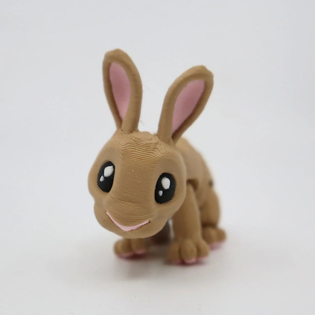Cute brown 3D printed rabbit sensory toy with big eyes on a white background