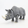 3D printed gray rhino sensory toy with movable joints on white background.