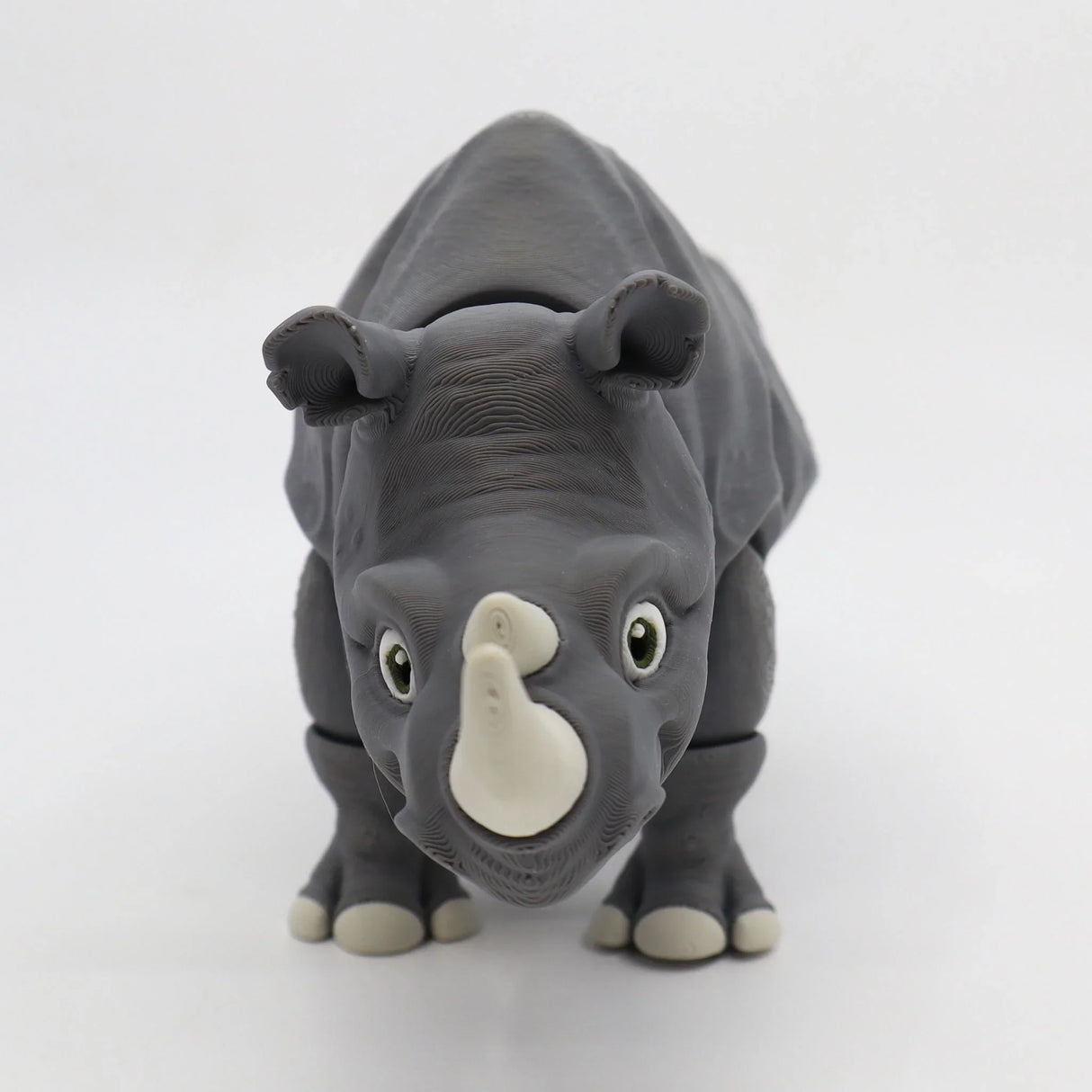 3D printed gray rhinoceros sensory toy with moveable joints on a white background