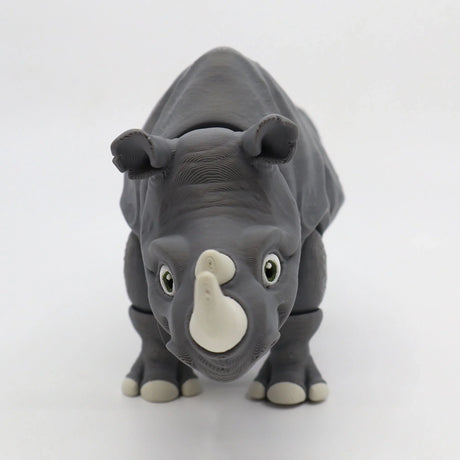 3D printed gray rhinoceros sensory toy with moveable joints on a white background