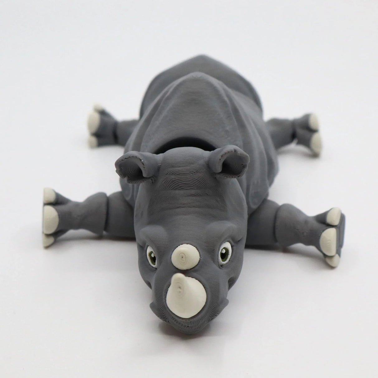 Gray 3D printed rhino sensory toy with movable limbs on white background