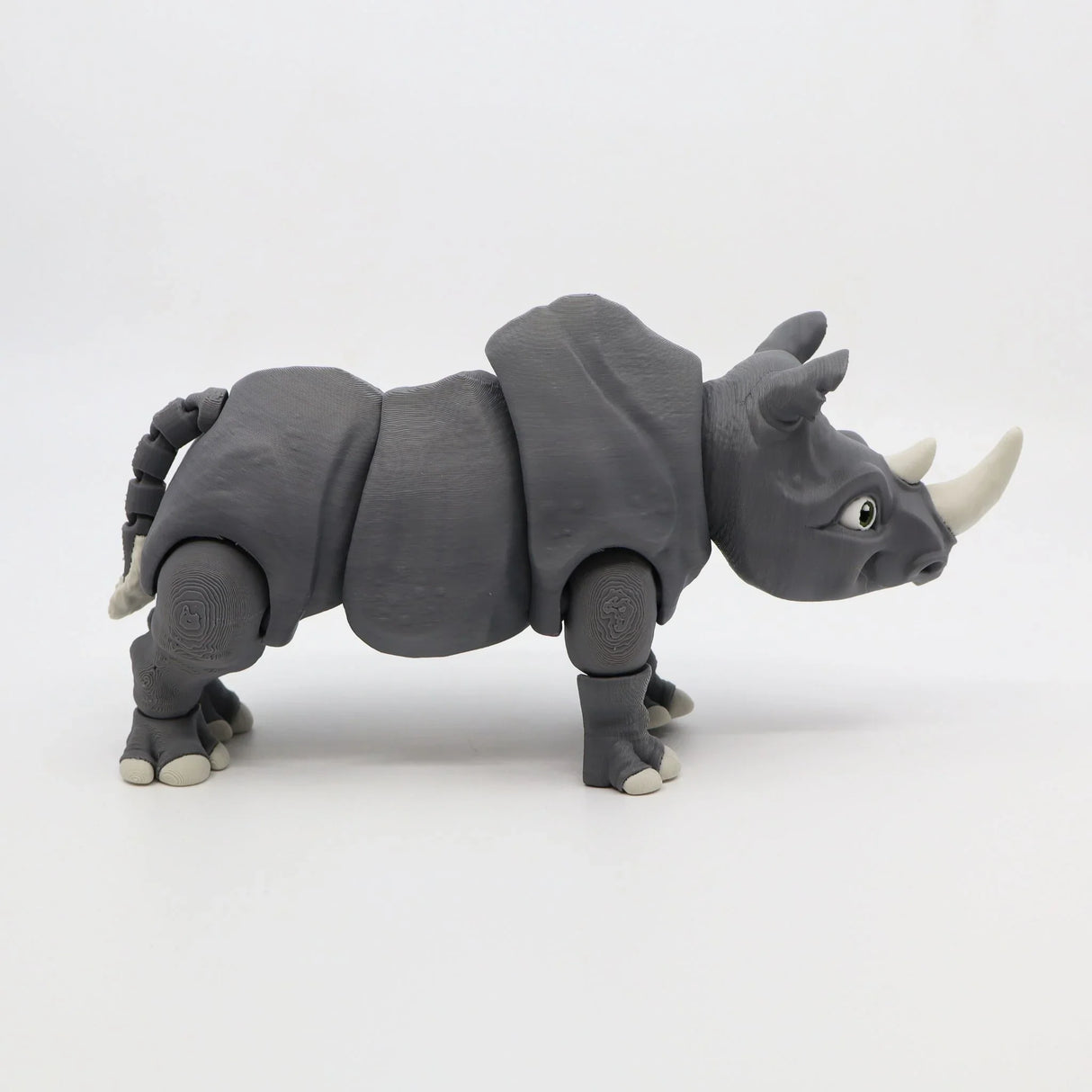 Gray 3D printed rhino sensory toy with movable joints on a white background