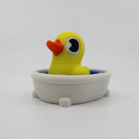 Yellow 3D printed duck fidget toy in white bath, sensory friendly for kids