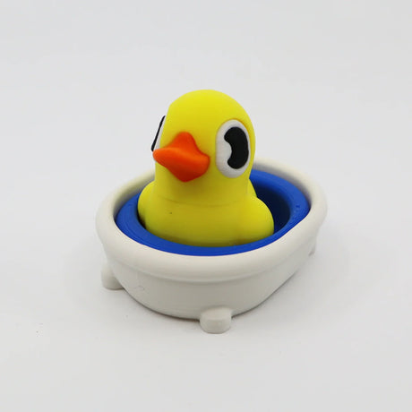 Yellow 3D printed duck fidget toy in white bath with blue water, sensory-friendly design for kids