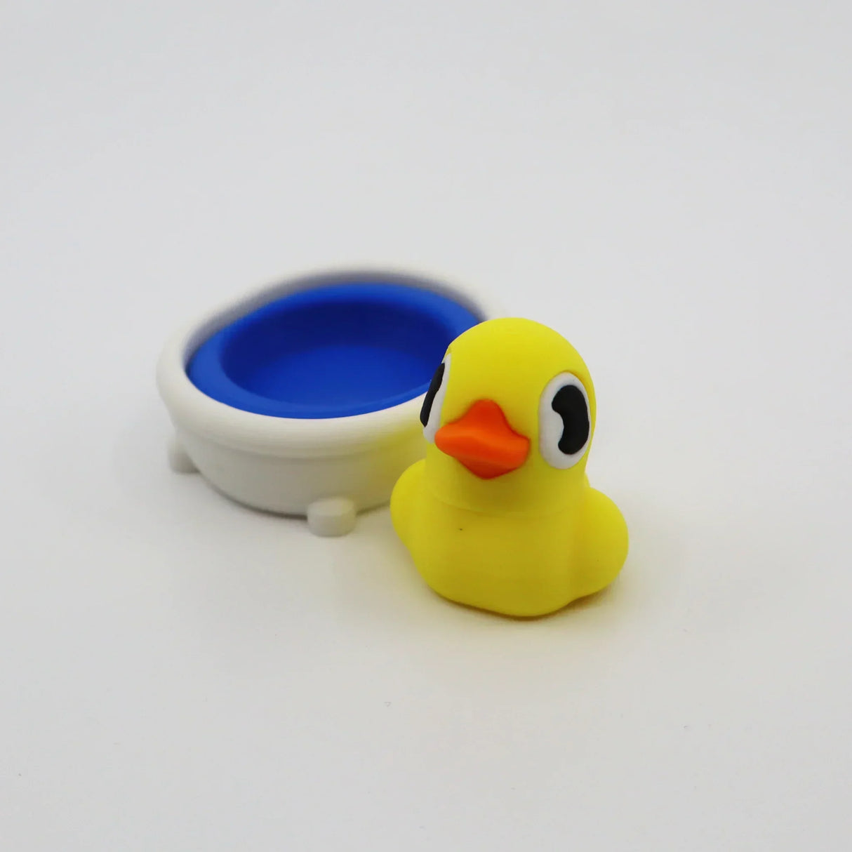 Yellow 3D printed duck fidget toy with blue bath, sensory-friendly design for kids
