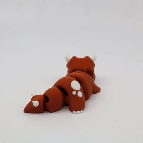 Brown 3D printed flexible animal fidget toy with white paws and horns on white background