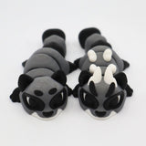 Two gray and black 3D printed sensory animal fidget toys with white horns on a white background