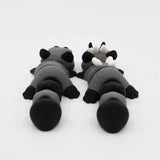 Two gray and black 3D printed sensory animal toys lying side by side on a white background.
