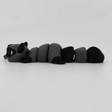 Gray and black 3D printed raccoon fidget toy with segmented, flexible body on white background