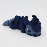 Blue 3D printed sensory fidget toy shaped like a dragon, resting on a white background