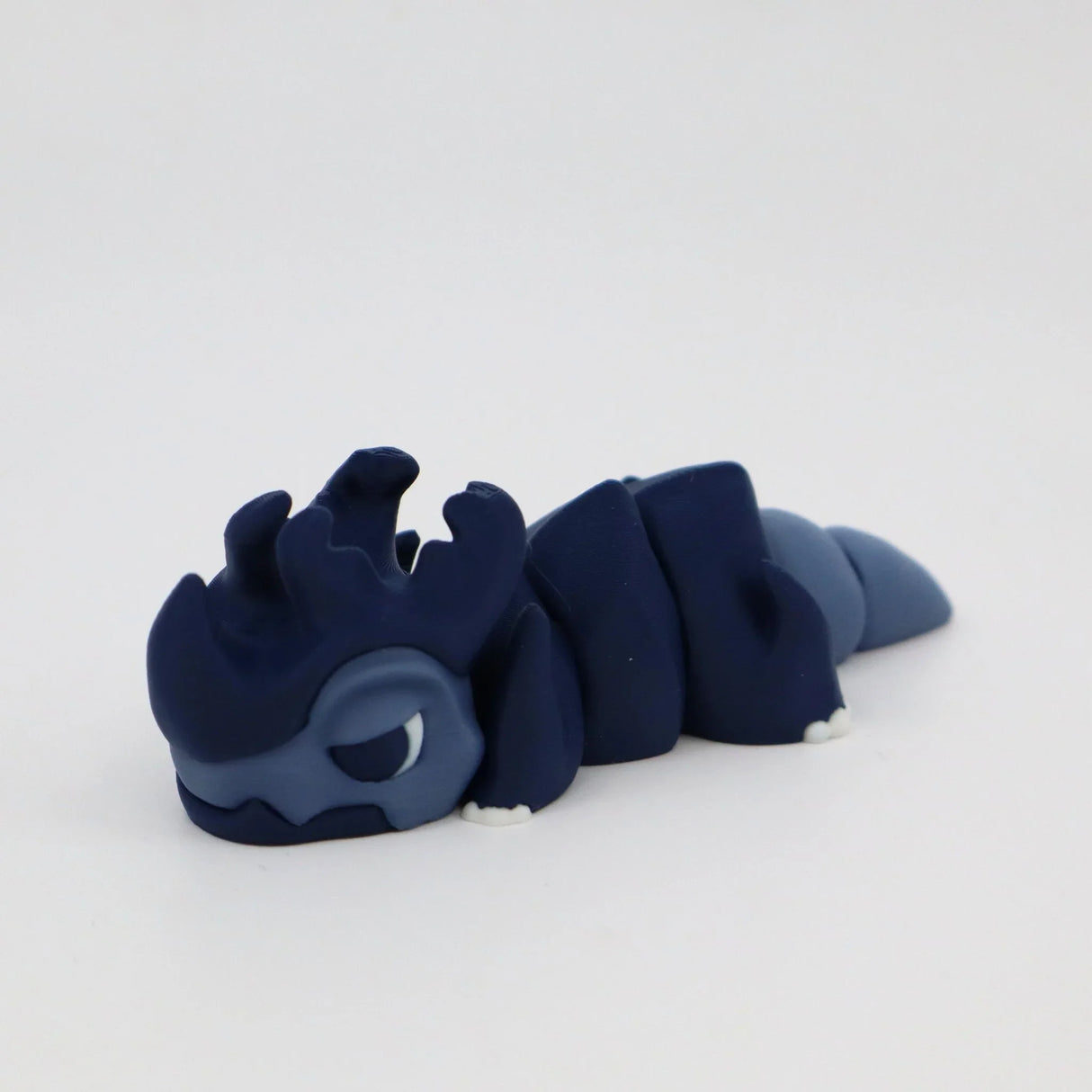 Blue 3D printed dragon sensory toy with segmented body on white background