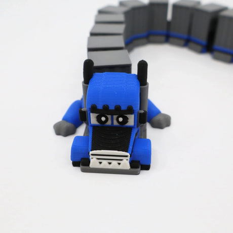 Blue 3D printed semi-truck fidget toy with flexible gray trailer for sensory play