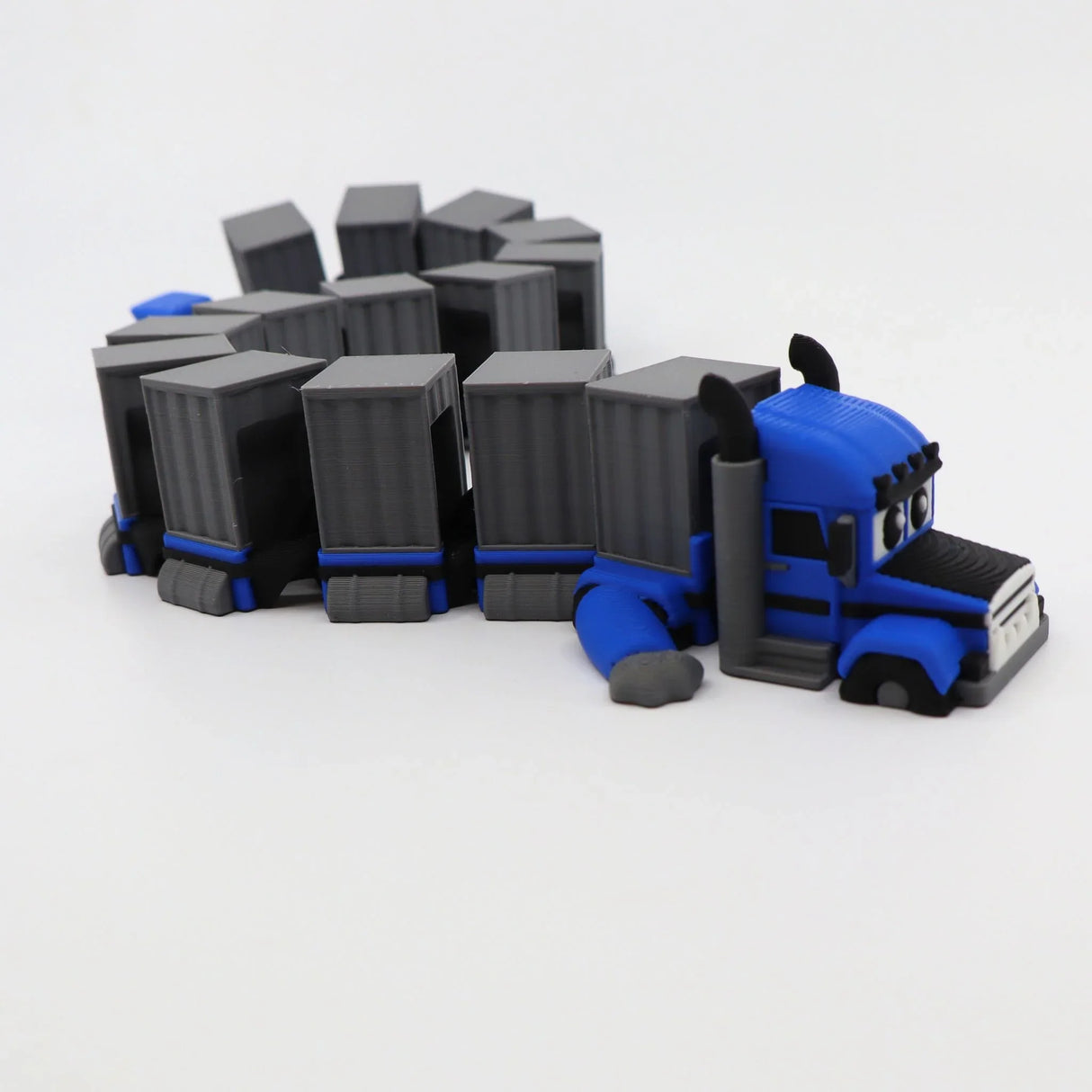 Blue 3D printed semi truck toy with gray cargo trailers, sensory fidget for kids