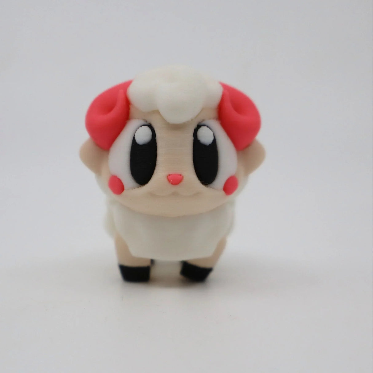 Cute 3D printed sensory sheep toy with big eyes, red horns, and soft pastel colors